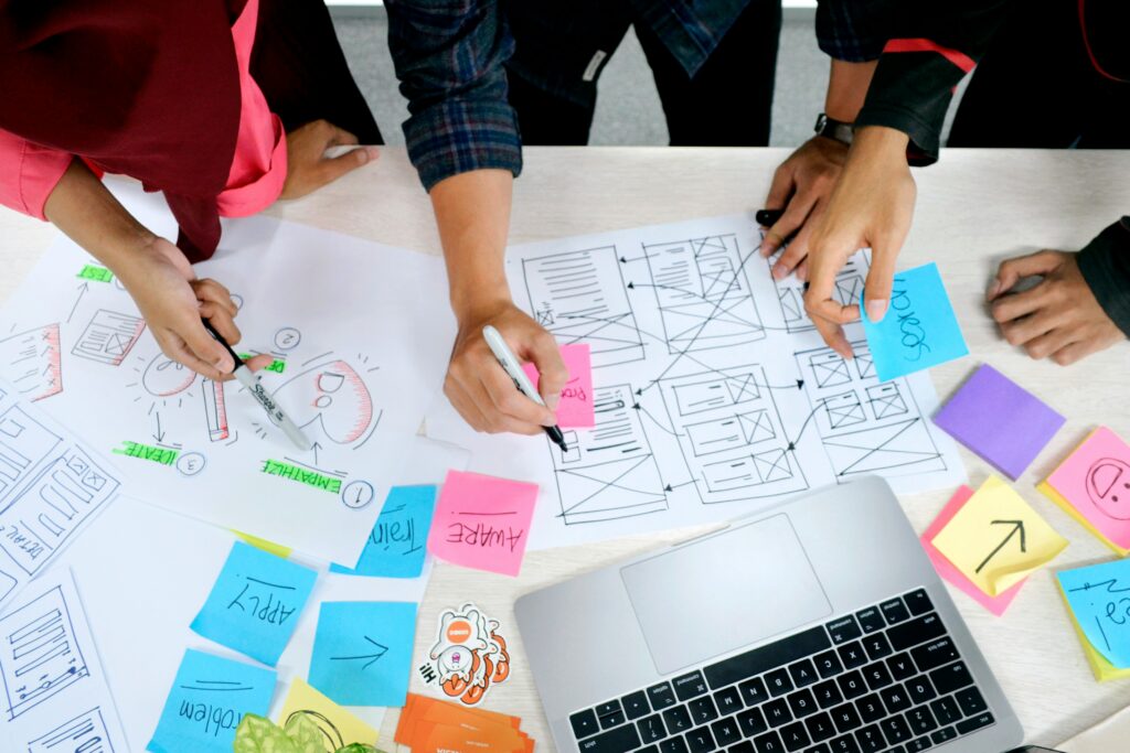 Image of people (only hands and notebook shown) of people immersed in research.
